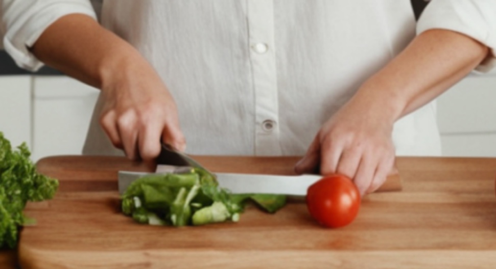 Close up of the tiffanirecipes[.]com photo where the knife, hands and lettuce are a jumbled mess.
